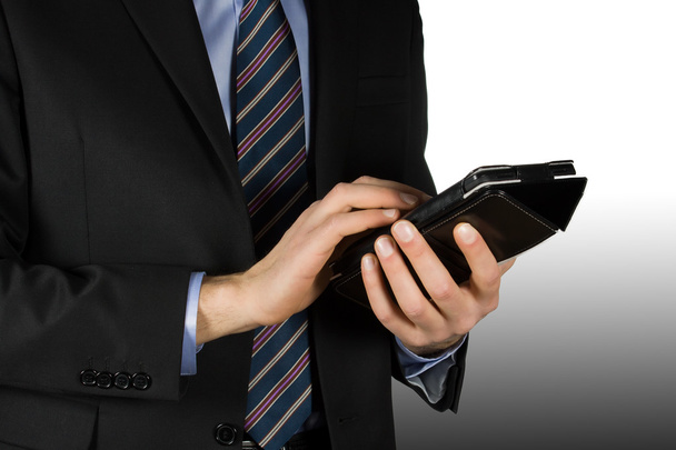 Businessman using a touchscreen device - Foto, afbeelding