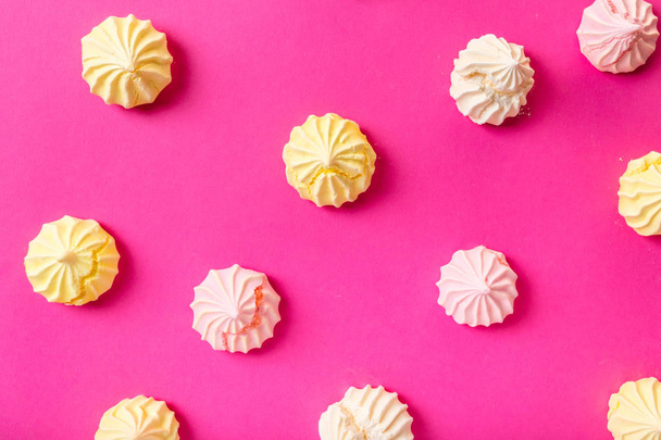 food background, dessert meringue on pink - 写真・画像