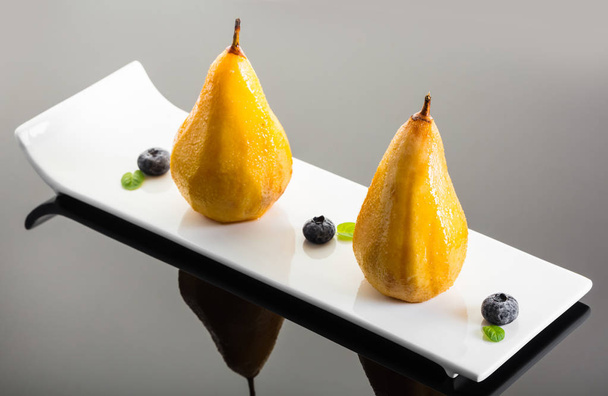 dessert, baked pear in honey syrup with berries - Photo, image