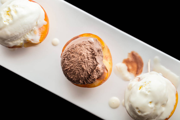 Dessert ice cream on peach, black background  - Photo, image