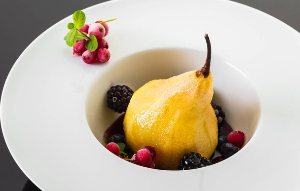 dessert, baked pear in honey syrup with berries - Photo, Image