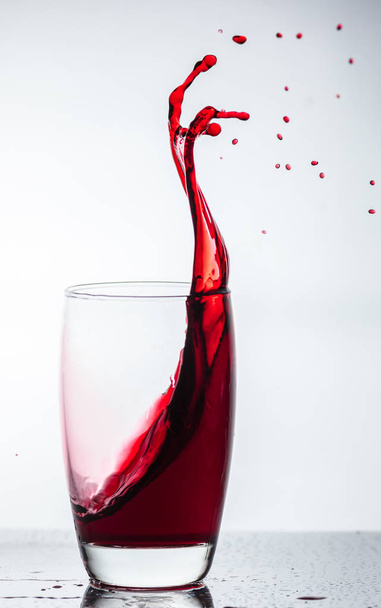 splash of drink from a glass with reflection - Photo, Image