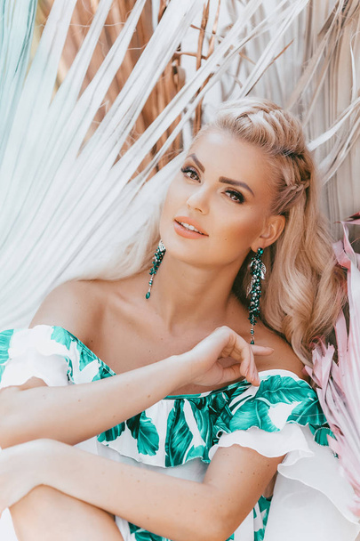Beautiful young ,blond woman posing in  tropical dress posing - Photo, image