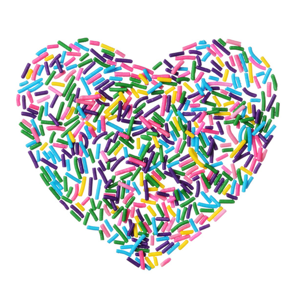 Coloridos caramelos espolvorea corazón aislado sobre fondo blanco
 - Foto, imagen
