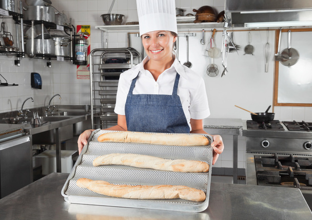 Female Chef Presenting Baked Breads - Photo, image