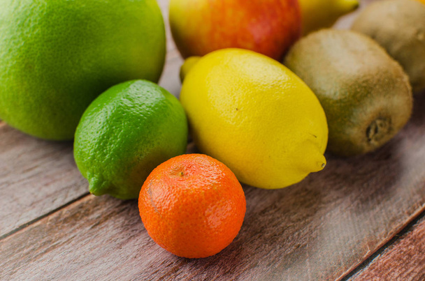 Citrus fruits orange, lemon, grapefruit, mandarin, lime on a wooden background - Valokuva, kuva