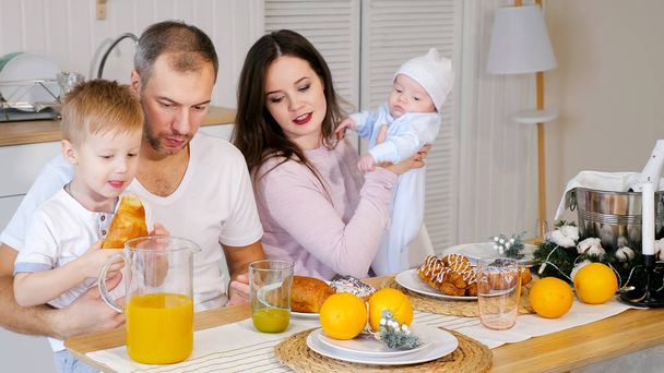 happy mother, father an son having breakfast at home - Foto, Imagem