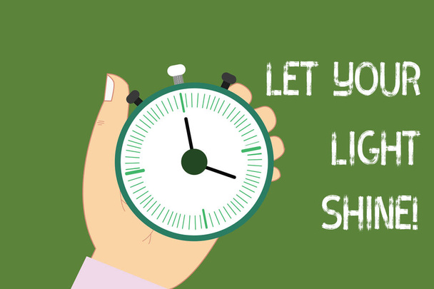 Conceptual hand writing showing Let Your Light Shine. Business photo showcasing Always be brilliant inspiring fabulous positive Hu analysis Hand Holding Stop Watch Timer Start Stop Button. - Photo, Image