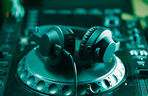 Headphones on CD music disc player for DJ. Top class audio equipment for studio,event,concert. Widely used by professional disc jockey. Macro, close up  - 写真・画像