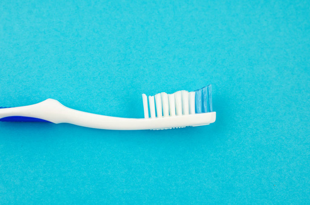 toothpaste and brush on a blue background with place for text. Health, cleanliness and beauty - Foto, Bild