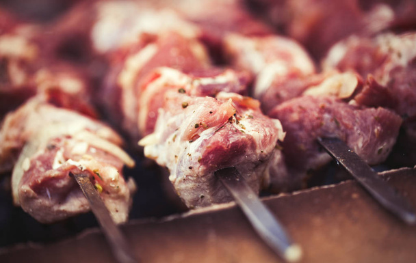 Process of cooking pork kebab meat on grill. This traditional southern dish is called Shashlyk in Georgia and Armenia.   - 写真・画像
