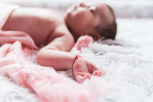little baby girl lying on bed in her bright cozy room - Foto, Imagen