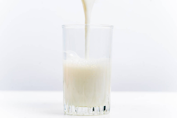 a glass of milk with bread and grains - Φωτογραφία, εικόνα