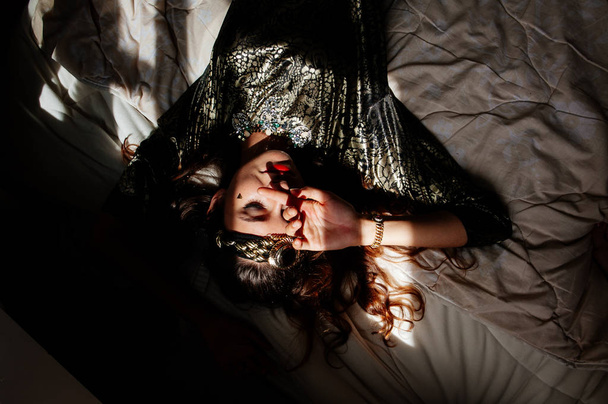 beautiful brunette woman posing in bed  - Fotó, kép