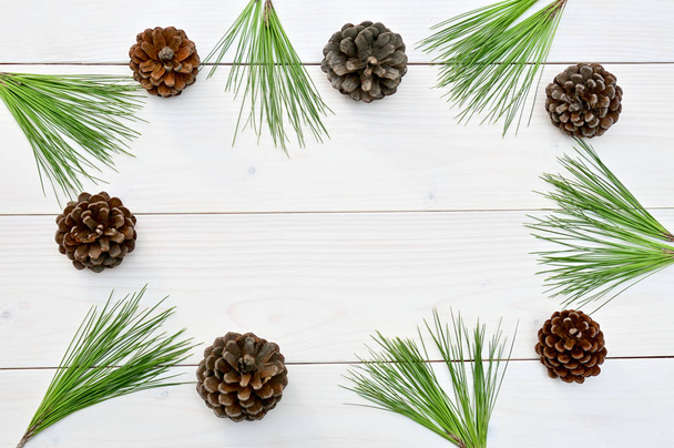 Christmas and New Year tree cones and branches on a white wooden background.Mockup & Flat Lay. - Φωτογραφία, εικόνα