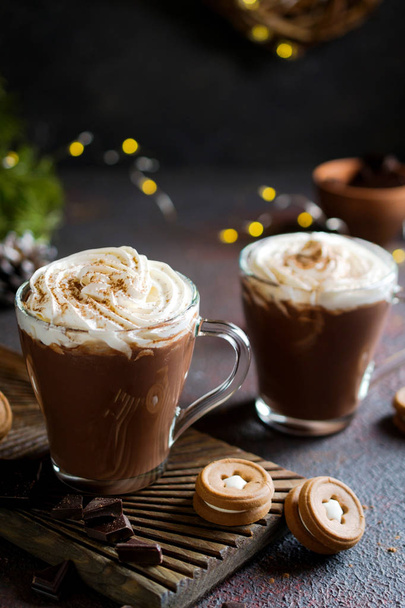 Cup of hot chocolate with whipped cream on top and winter decor. Traditional drink for autumn or winter holidays, copy space. - Фото, зображення