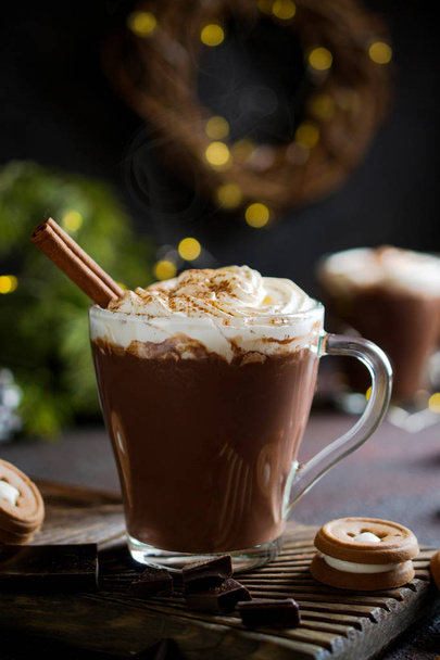 Cup of hot chocolate with whipped cream on top and winter decor. Traditional drink for autumn or winter holidays, copy space. - Фото, изображение
