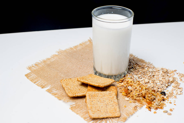 a glass of milk with bread and grains - Valokuva, kuva