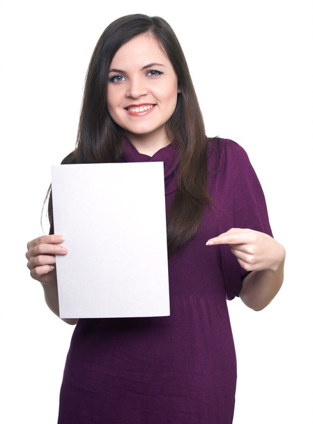 Attractive young woman in a dress. Woman holds a poster and poin - Photo, Image