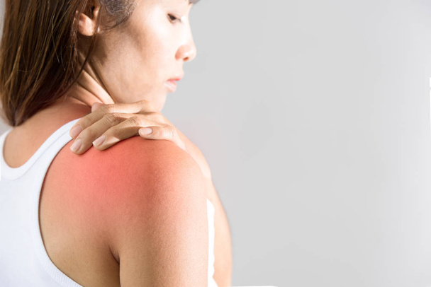 woman holding hand on skin around right shoulder joint with inflammation color  - Photo, image
