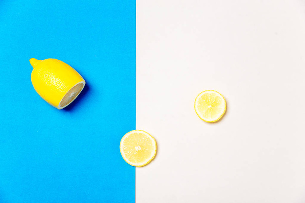 a banana and a lemon on colorful background - Photo, Image