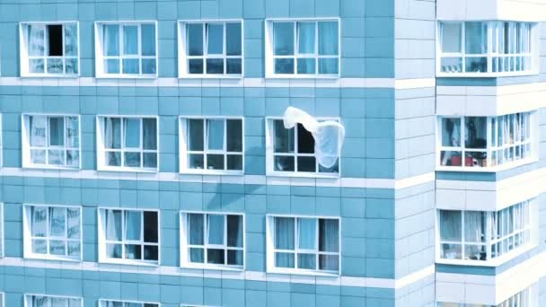 Vorhang flattert im Wind von der Außenseite eines Fensters an einem Mehrfamilienhaus, abstrakter Minimalismus - Filmmaterial, Video