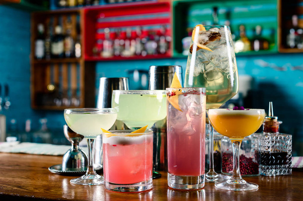 set of Classic alcoholic cocktails on bar counter in pup or restaurant with copy space - 写真・画像