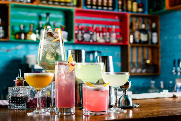 set of Classic alcoholic cocktails on bar counter in pup or restaurant with copy space - Fotó, kép