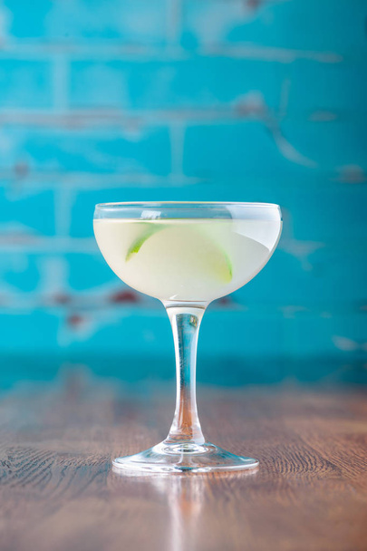 Traditional classic cocktail daiquiri, image for the menu. decorated with lime at bar background. Space for text - Foto, Bild