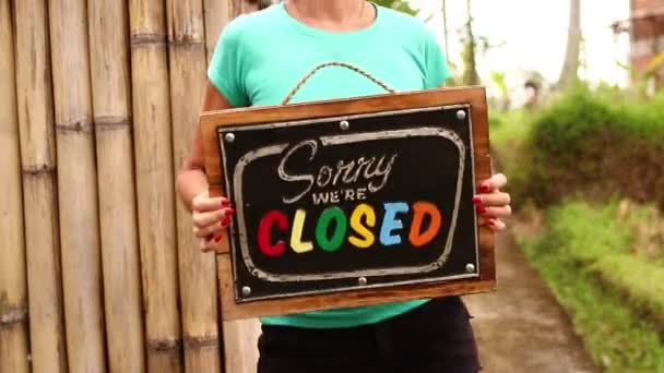 Woman hands with closed sign board on a tropical nature background. Bali island. - Footage, Video