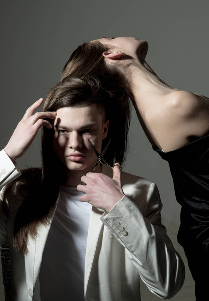 Hair cut by man with scissors. Beauty and fashion. Friendship relations. Family bonds. Hair style and skincare. Man and woman. Fashion couple in love. Feeling fresh after haircut - 写真・画像