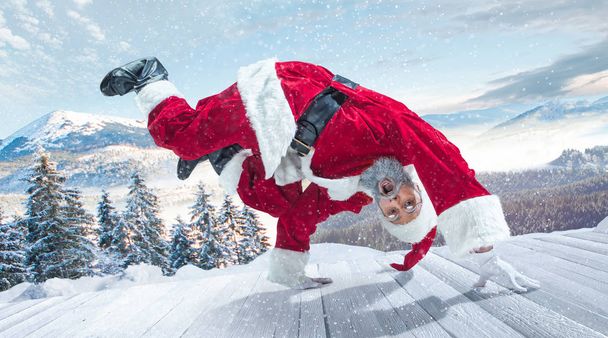 Santa Claus with traditional red white costume in front of white snow winter landscape panorama - Foto, Bild