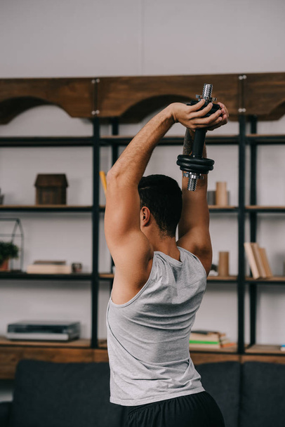 man holding dumbbell over head  - Photo, Image