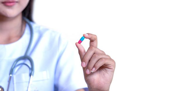 doctor holding capsule medication on white background  - Фото, изображение