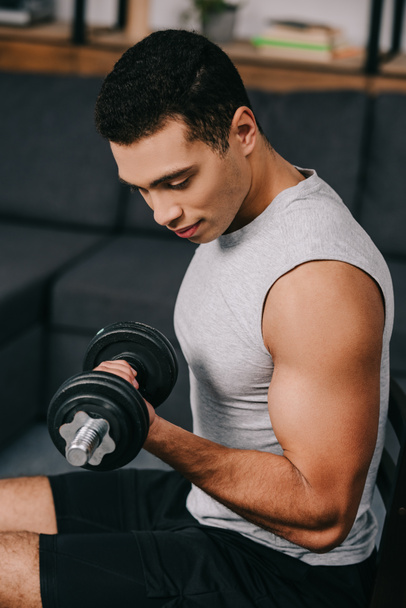 strong muscular mixed race man training with heavy dumbbell  - Fotoğraf, Görsel