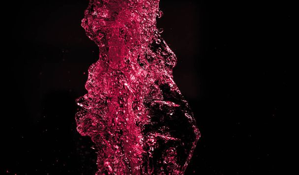 colored water splashes on black background  - Фото, зображення