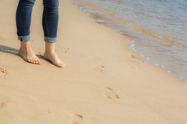 Donna che cammina sulla spiaggia sulla sabbia
  - Foto, immagini