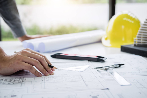 Construction engineering or architect hands working on blueprint inspection in workplace, while checking information drawing and sketching for architecture project working. - 写真・画像
