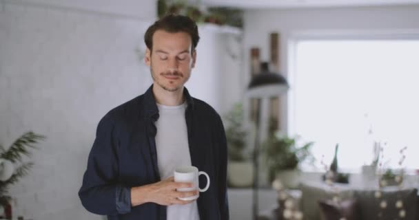 Adult male having morning coffee in kitchen - Materiał filmowy, wideo