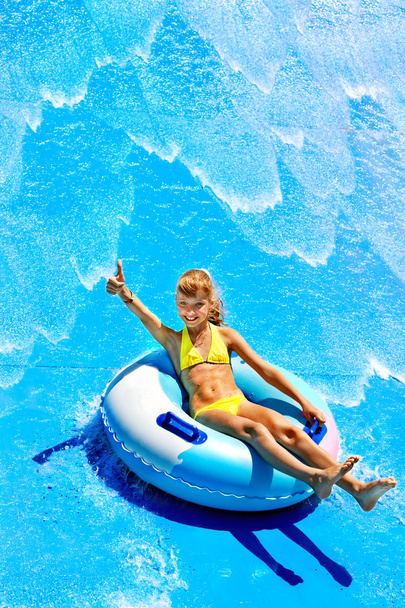 Child on water slide at aquapark. - Photo, Image