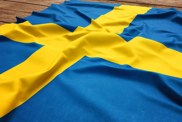 Flag of Sweden on a wooden desk background. Silk Swedish flag top view. - Foto, afbeelding
