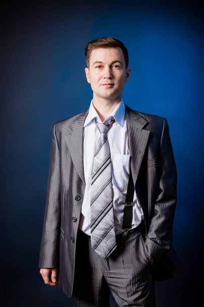 Man in a grey suit in a photo Studio. - Photo, Image