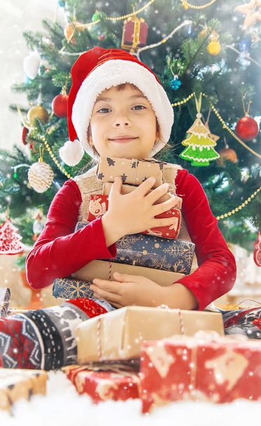 Child happy over christmas background. Christmas tree. Selective focus. Holidays - Photo, Image