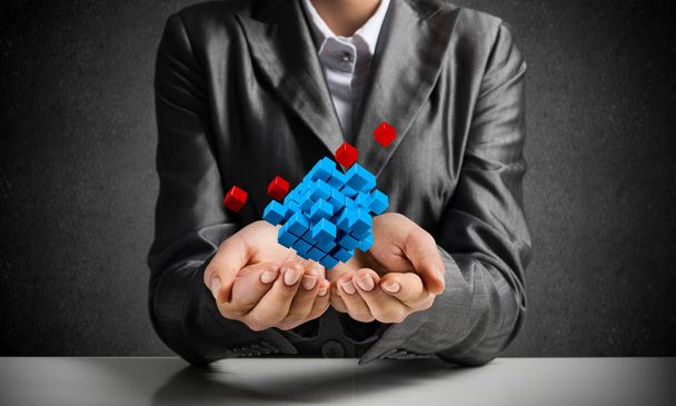 Cropped image of business woman in suit presenting multiple cubes in hands as symbol of innovations. 3D rendering. - Photo, Image