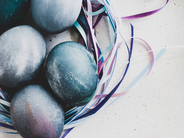 Easter eggs painted with bright colors on a white background. Top view, close-up, isolated. Happy Easter Preparation for the holiday - Foto, Bild