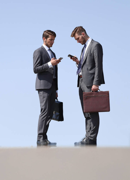 business colleagues with mobile phones standing on the street - Foto, immagini
