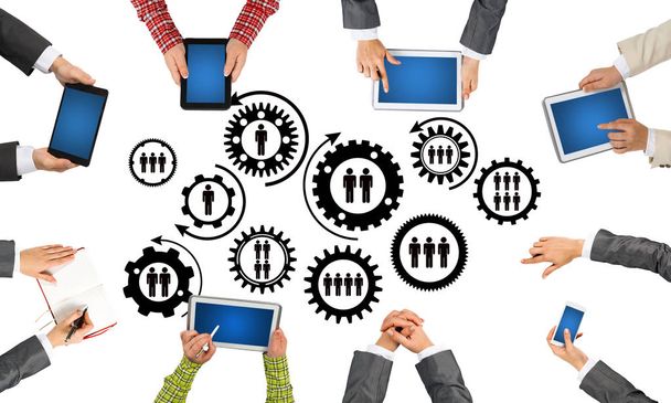 Group of people with devices in hands working together as symbol of networking and communication - Foto, imagen