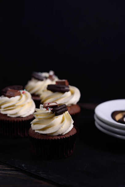 Chocolate, tasty and sweet cupcake with vanilla cream and condensed milk inside, - Foto, Bild