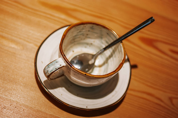 Empty ceramic cup on wooden table - Fotografie, Obrázek
