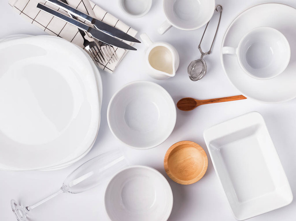 Different tableware and dishes on the white background, top view. - Фото, изображение
